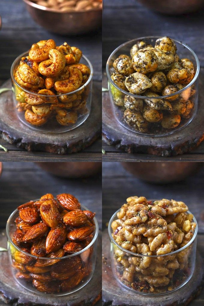 four different bowls filled with nuts on top of a wooden table