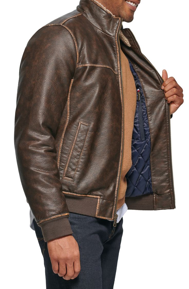 Ultrasoft faux-shearling lining offers ultimate warmth into this faux-leather jacket styled with handy pockets. 27" length Front zip closure Stand collar Front welt pockets Water resistant Lined, with synthetic fill 100% polyurethane with 100% polyester faux shearling Machine wash, tumble dry Imported Casual Brown Leather Jacket With Fleece Lining, Fitted Brown Outerwear With Fleece Lining, Spring Brown Outerwear With Fleece Lining, Brown Leather Jacket With Zipper For Cold Weather, Casual Leather Outerwear With Fleece Lining, Winter Leather Biker Jacket With Faux Pockets, Brown Faux Leather Biker Jacket For Winter, Casual Faux Leather Outerwear With Zip Fly, Casual Leather Jacket With Fleece Lining For Fall