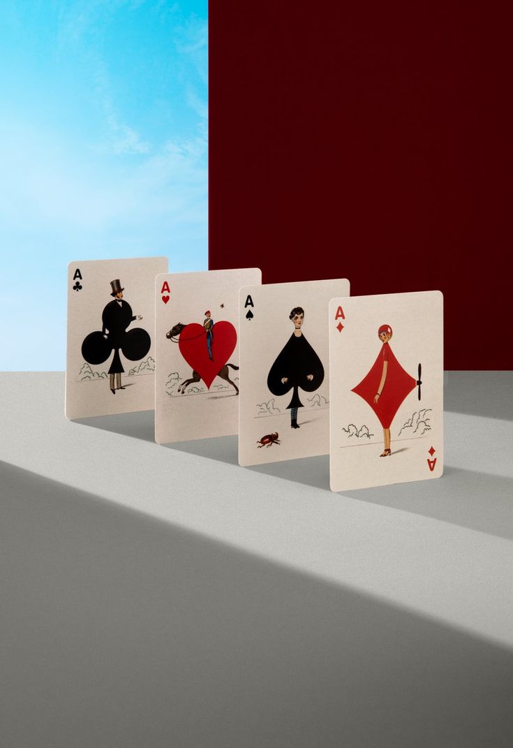 four playing cards with the same design on each card, all in different shapes and sizes