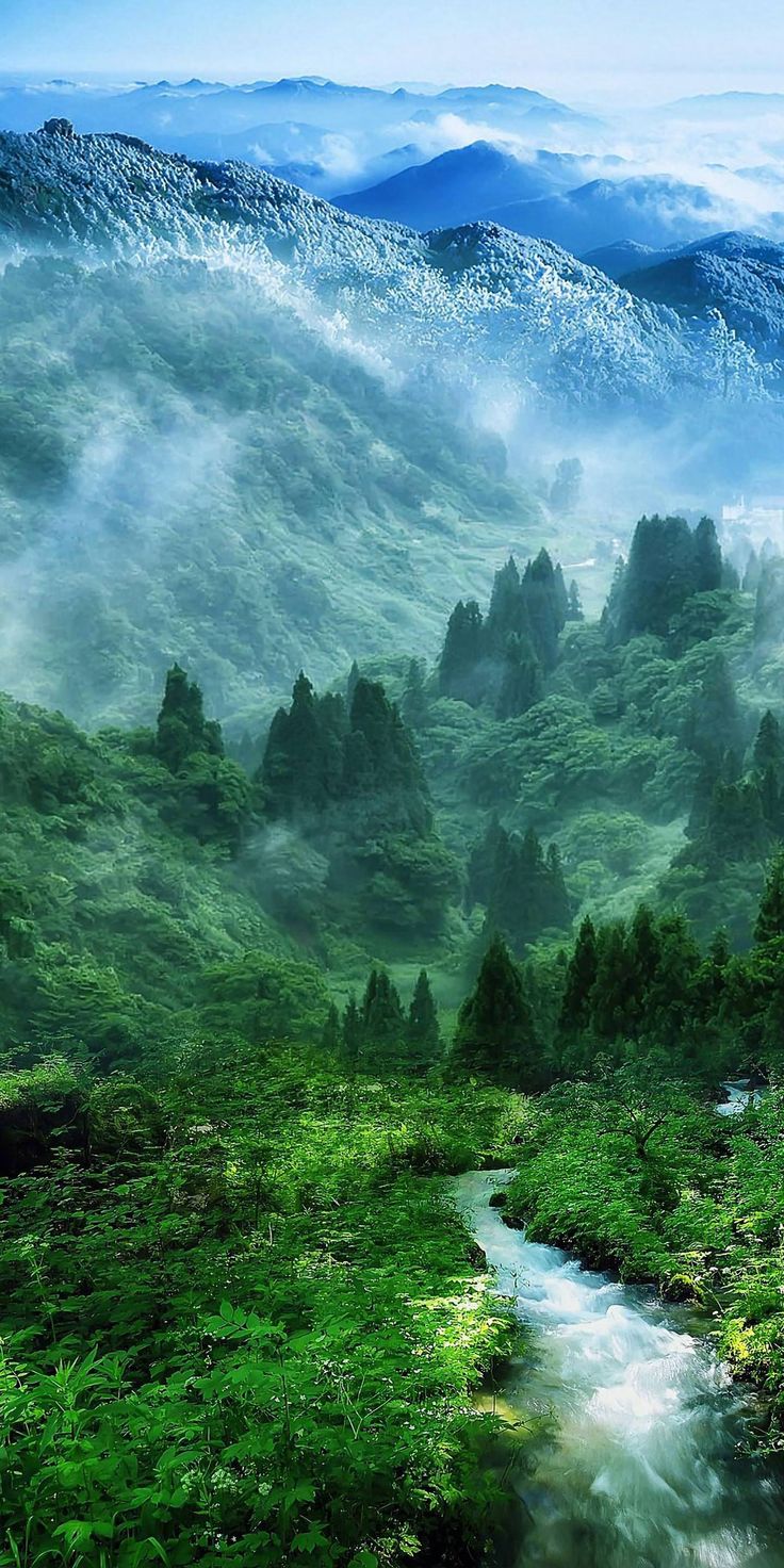 a painting of a mountain landscape with green grass and trees in the foreground is a river running through it