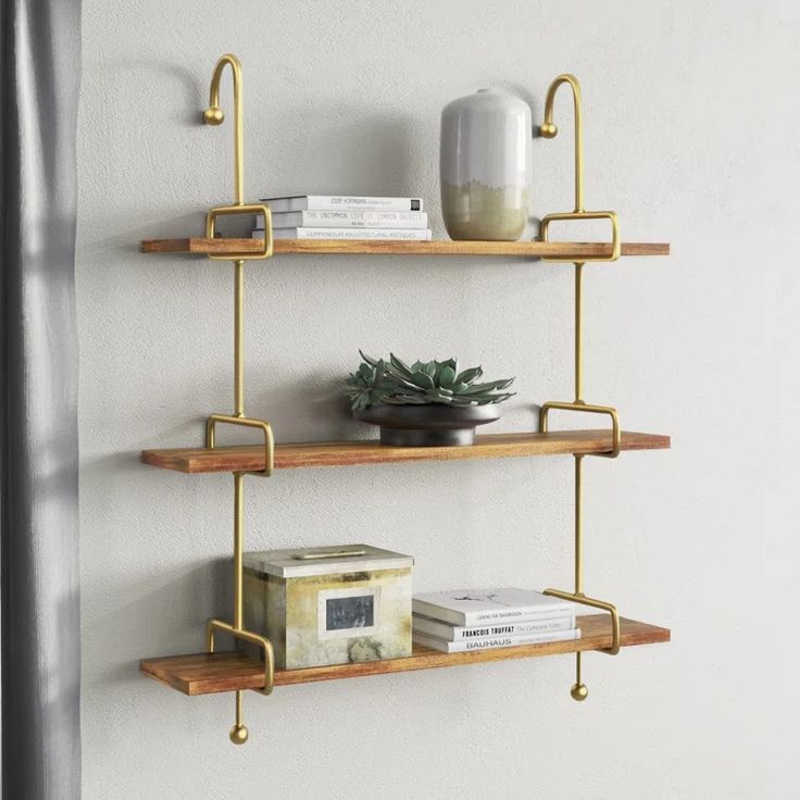 three wooden shelves with metal brackets on each shelf and a potted plant next to them