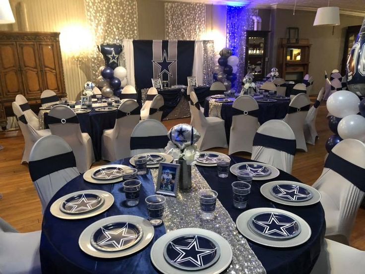 a room filled with tables covered in blue and white table cloths, plates and silverware