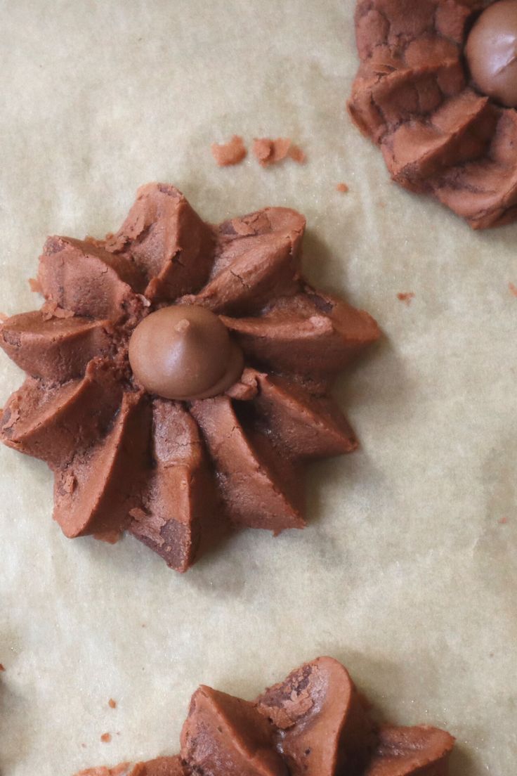 some chocolates are laying on top of a piece of parchment paper and ready to be baked