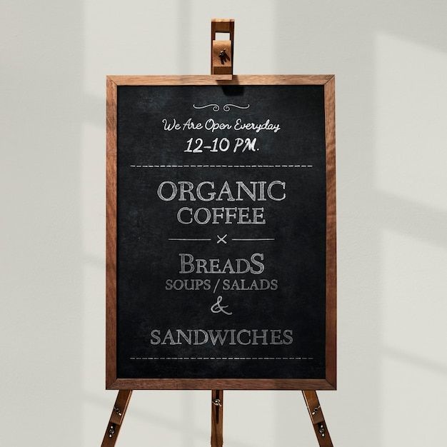 a blackboard sign advertising organic coffee and breads for sandwiches, sandwiches and sandwiches