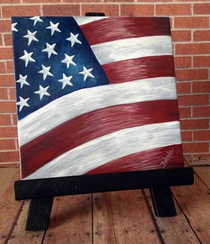 an american flag painted on a wooden easel