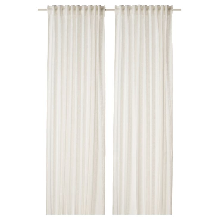 two white curtains hanging on a wall