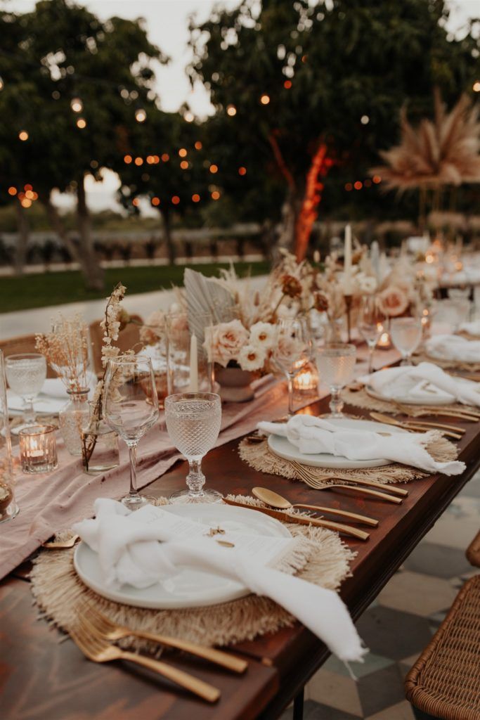 a long table set with place settings for dinner