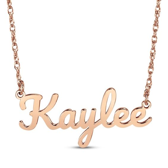 Show off what makes you unique or surprise someone special with this customized name necklace. Styled in an elegant script font, the name of your choice—up to 9 letters—is crafted in 14K rose gold and centered amidst a festoon rope chain. The 16-inch necklace has a 2-inch extender and secures with a spring ring clasp. Elegant Rose Gold Name Necklace For Personalized Gift, Rose Gold Initials Name Necklace For Anniversary, Customized 14k Rose Gold Name Necklace, Signature Rose Gold Jewelry With Name Detail, Mother's Day Rose Gold Nameplate Necklace, Personalized Signature Rose Gold Jewelry, Rose Gold Nameplate Name Necklace, Custom Name Rose Gold Necklace For Anniversary, Signature Rose Gold Jewelry For Personalized Gift