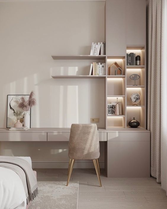 a bedroom with a bed, desk and shelves in the wall next to each other