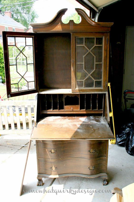 an old wooden desk with stained glass doors