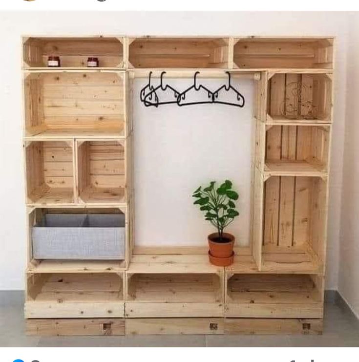 a wooden shelf that has some shelves on top of it and a potted plant next to it