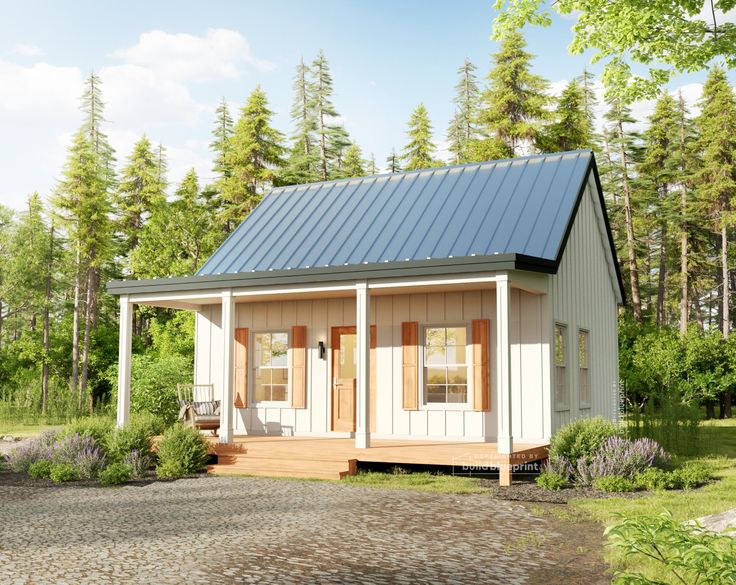 a small white cabin with a porch and windows on the front, surrounded by trees