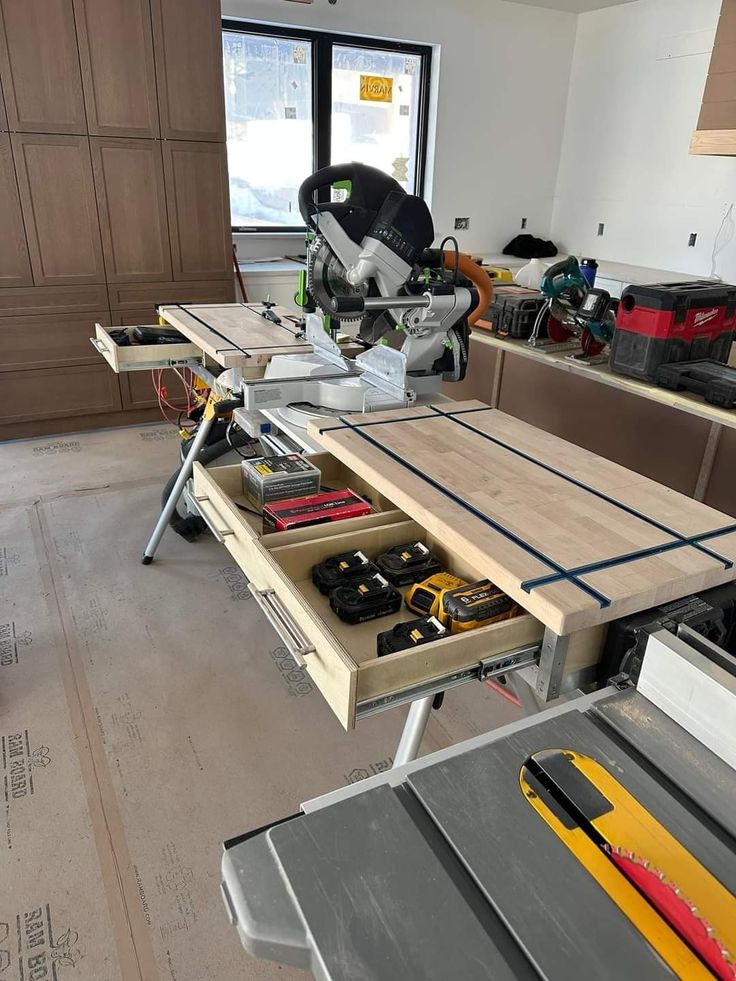 a workbench with tools on it in a room that is being worked on