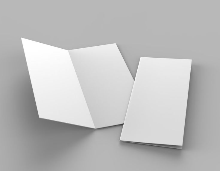 two open white folders sitting next to each other on a gray surface with one opened and the other closed