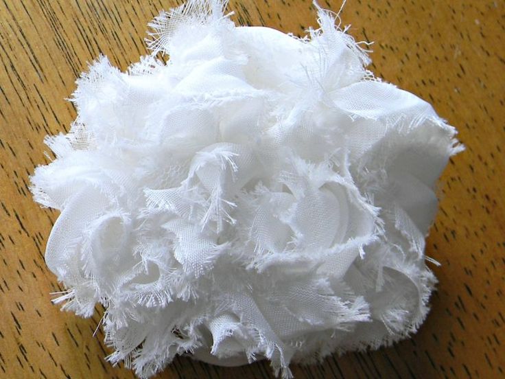 a white piece of fabric sitting on top of a wooden table