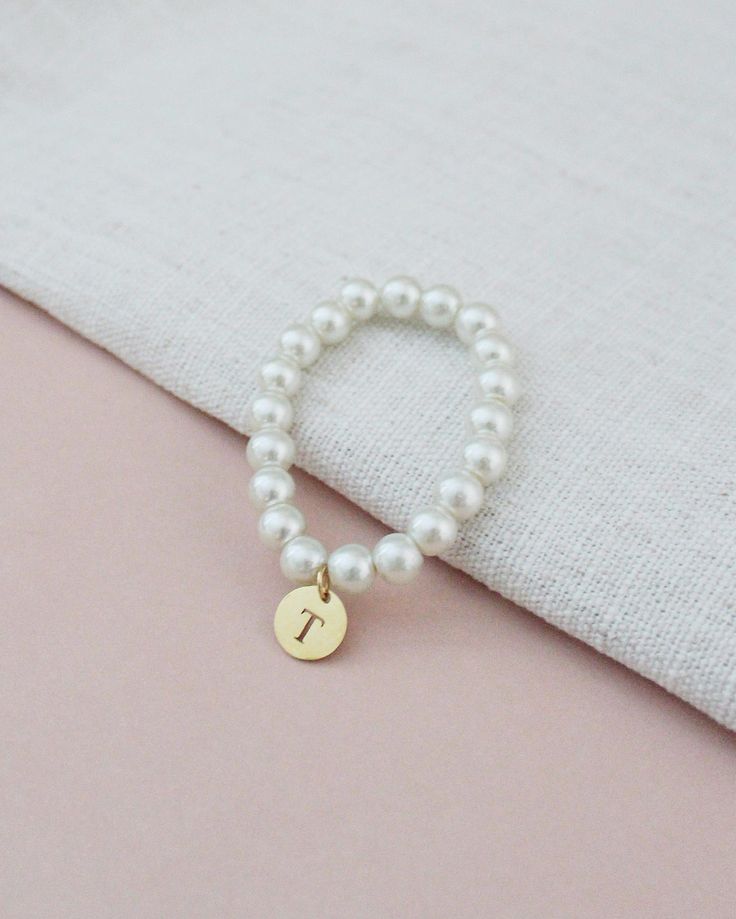 All time classic pearls bracelet with added initial to complete your look. Choose from silver, rose gold, or gold initials to match with your personality and give a modern touch on a traditional style.Great for bride or for birthday gifts, flower girls, brides or or bridesmaids to wear on the wedding day. ** Please put the preferred letter initial on notes upon checkout ** This listing is only for 1 bracelet. Bracelet is measured to approximately 7 - 8 inches, however, it can stretch to match wr Pearls Bracelet, Ivory Pearl, Gold Initial, Flower Girls, Monogram Initials, Silver Rose Gold, Pearl Bracelet, On Shoes, Traditional Style