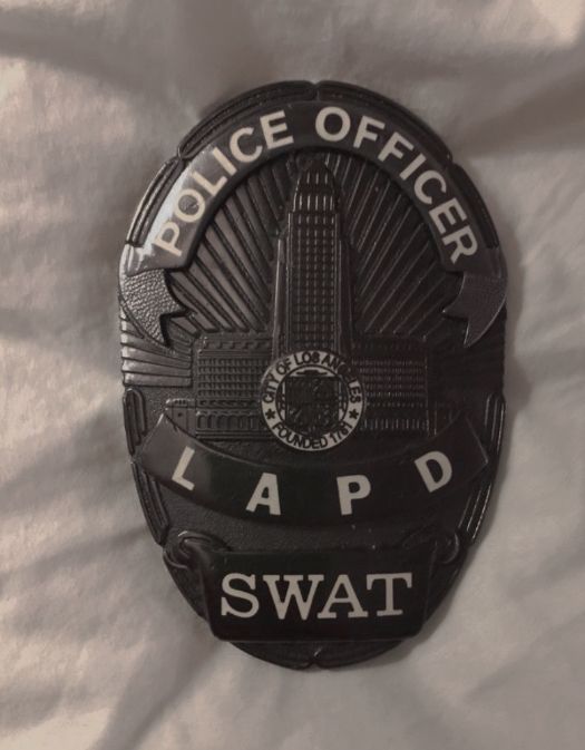 the lapd swat badge is on a white sheet