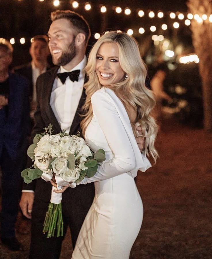 the bride and groom are smiling at each other as they walk down the aisle together