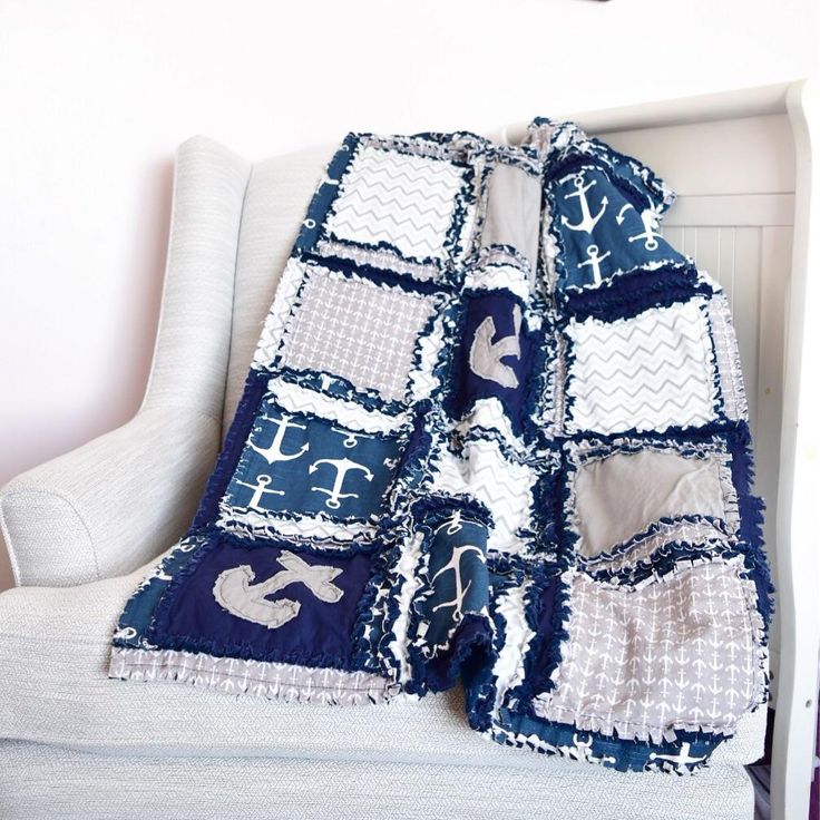 a blue and white blanket sitting on top of a couch