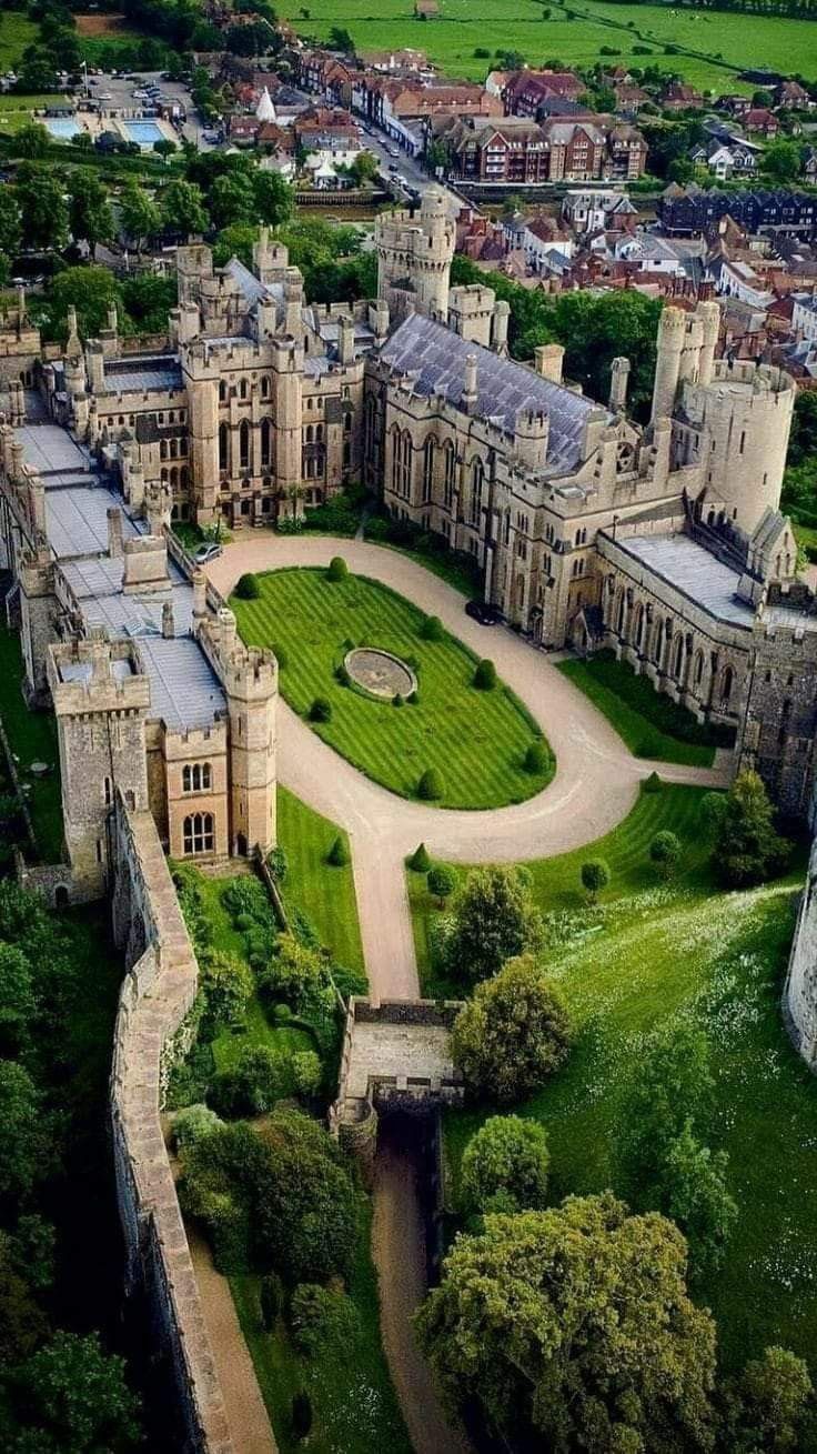 an aerial view of a castle with lots of green grass