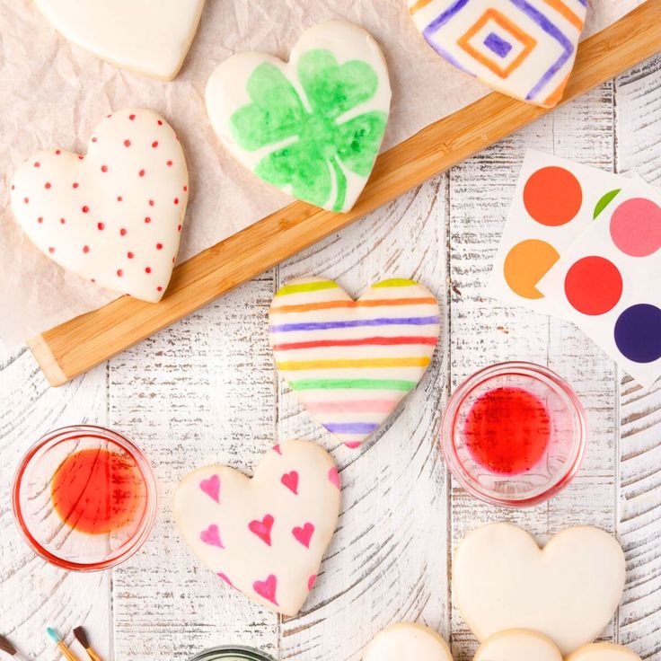 some cookies are on a table with paint