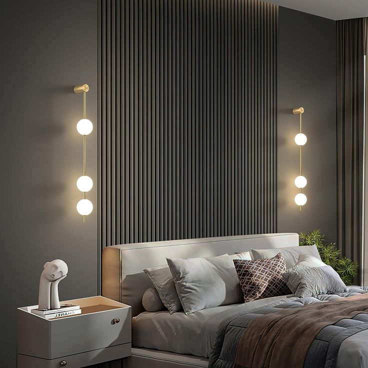 a bedroom with grey walls and white bedding has three lights on the headboard