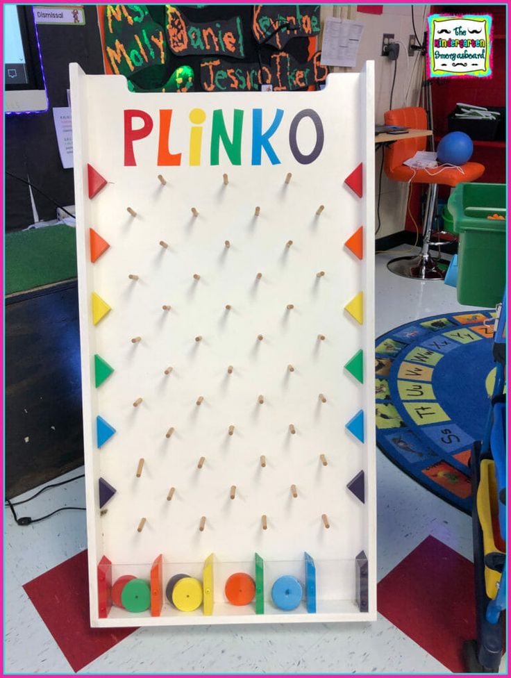 a sign that says plinko on it with pins stuck in the front and back