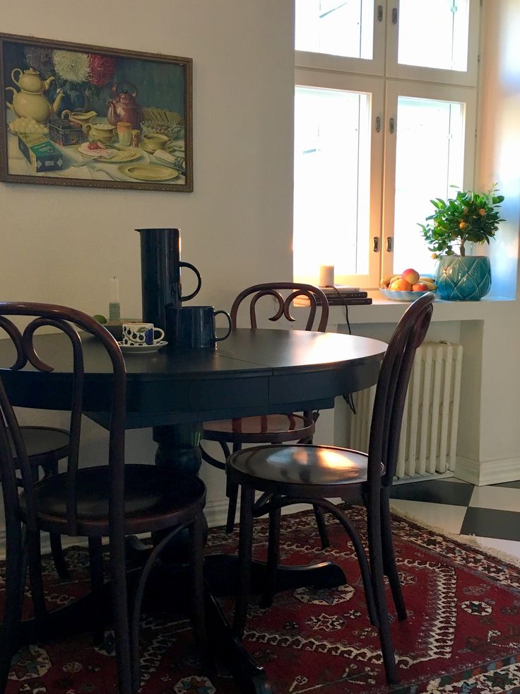 a dining room table with four chairs around it