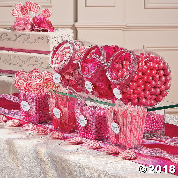 a table topped with lots of candy and lollipops on top of it