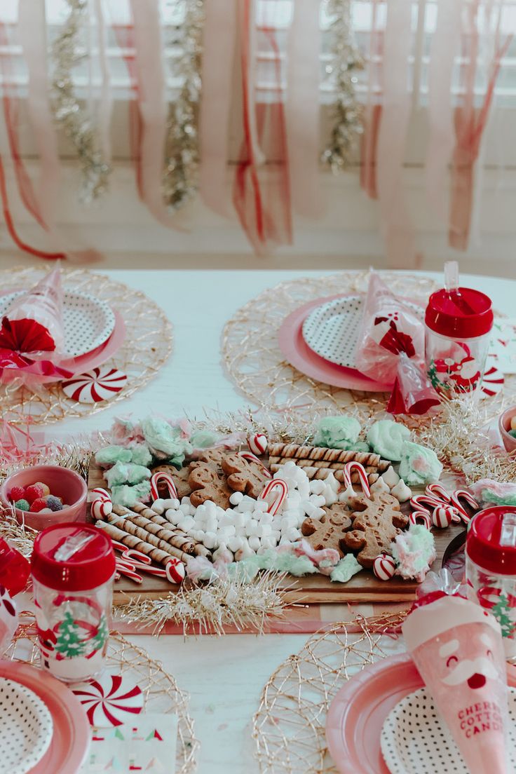 a table set for christmas with candy canes and cookies