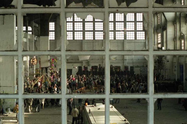 people are standing in an old building looking through the window panes at something else