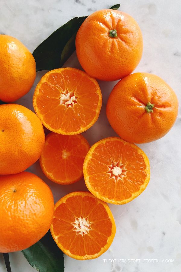 several oranges are arranged on a marble surface