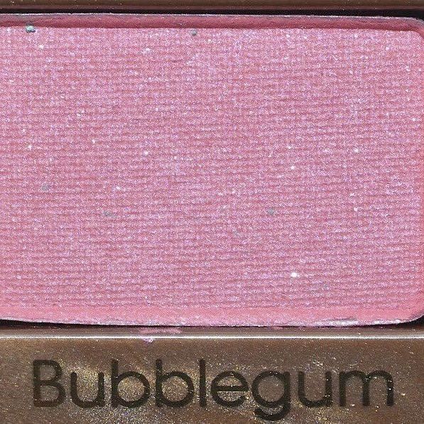 a close up of a pink eye shadow on top of a brown box with the word bubblegum written in it