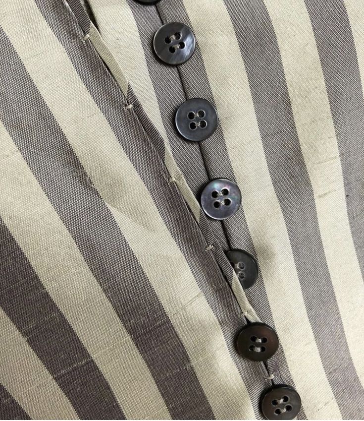 a striped shirt with buttons on it