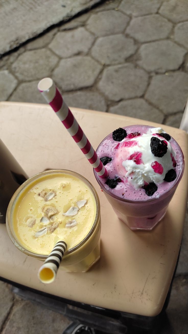 an ice cream sundae and milkshake are sitting on a table