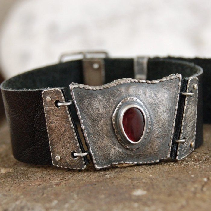 "Garnet silver leather bracelet. Dimensions: -garnet 0.6 - 0.9 cm, 0.24 - 0.35\" -main silver element 2.3 - 2.8 cm, 0.9 - 1.1\" -width of strap 2.2 cm, 0.87\" -circuit 16 - 18 cm, 6.3 - 7.1\"" Leather Bracelet With Palladium Hardware As Gift, Silver Leather Bracelets For Formal Occasions, Formal Silver Leather Bracelets, Silver Leather Bracelet With Sterling Clasp As Gift, Adjustable Silver Leather Bracelet With Sterling Silver Clasp, Silver Leather Cuff Bracelet As Gift, Silver Leather Cuff Bracelet Gift, Modern Silver Leather Bracelet With Sterling Clasp, Silver Bracelets With Leather Strap