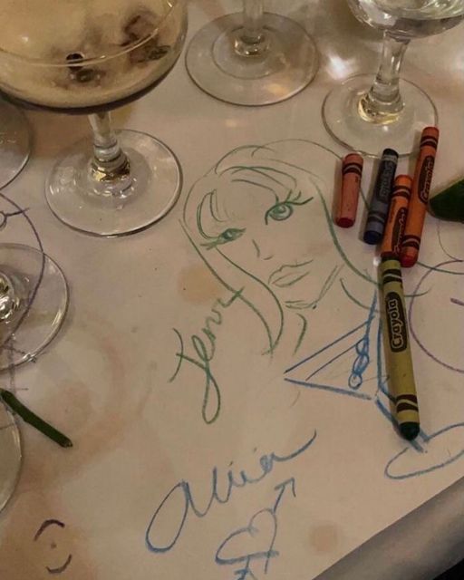 a table topped with wine glasses and markers