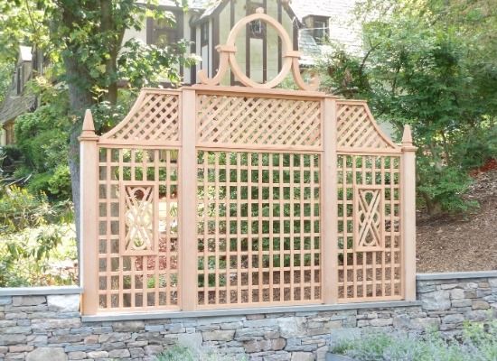 a wooden fence with an intricate lattice design