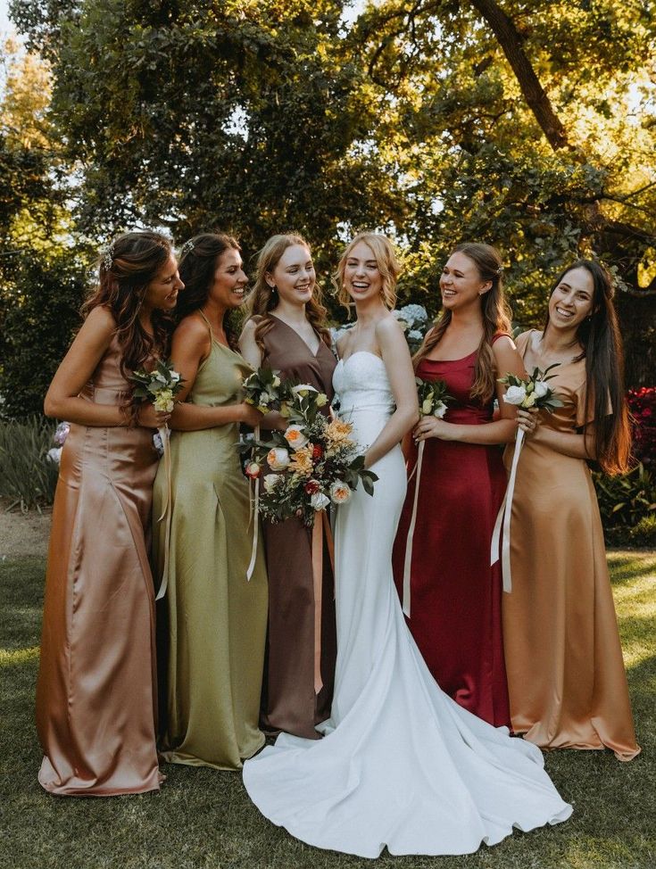 a group of women standing next to each other on top of a lush green field