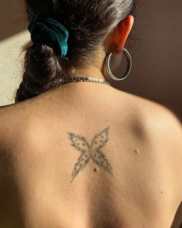 a woman with a tattoo on her back