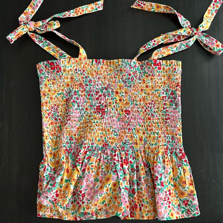 J Crew Multi Color Floral Print Smocked Tank Top. Adjustable Tie Shoulder Straps. Great Condition, Never Worn Multicolor Sleeveless Smocked Back Top, Multicolor Smocked Cotton Top, Multicolor Smocked Bodice Cotton Top, Multicolor Summer Top With Smocked Cuffs, Summer Multicolor Top With Smocked Cuffs, Multicolor Sleeveless Smocked Top With Floral Print, Spring Multicolor Tops With Drawstring, Multicolor Cotton Smocked Top With Ruffles, Multicolor Ruffled Cotton Smocked Top