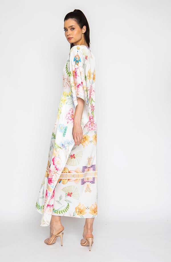 Bring out your inner flower in the Botanica Long Caftan. This gorgeous piece of apparel features delicate flowering patterns, giving you the freedom to show off your unique style. And the airy fabric won’t weigh you down, meaning you can wear your beauty around the clock! Bloom into something special with the Botanica Long Caftan. Printed short caftan Can be worn loose or cinched at the waist Comes with a matching belt as an option for styling Lusciously soft poly-silk blend for ease of care Mac White V-neck Floral Print Kaftan, Silk Kaftan With Floral Print And V-neck, Silk Floral Print Kaftan For Beach Cover-up, Spring Floral Print V-neck Kaftan, Flowy Silk Maxi Length Kimono, Bohemian Silk Kimono With Floral Print, Silk Maxi-length Printed Kimono, Silk Kaftan With Floral Embroidery For Spring, White Floral Print Kimono For Festival