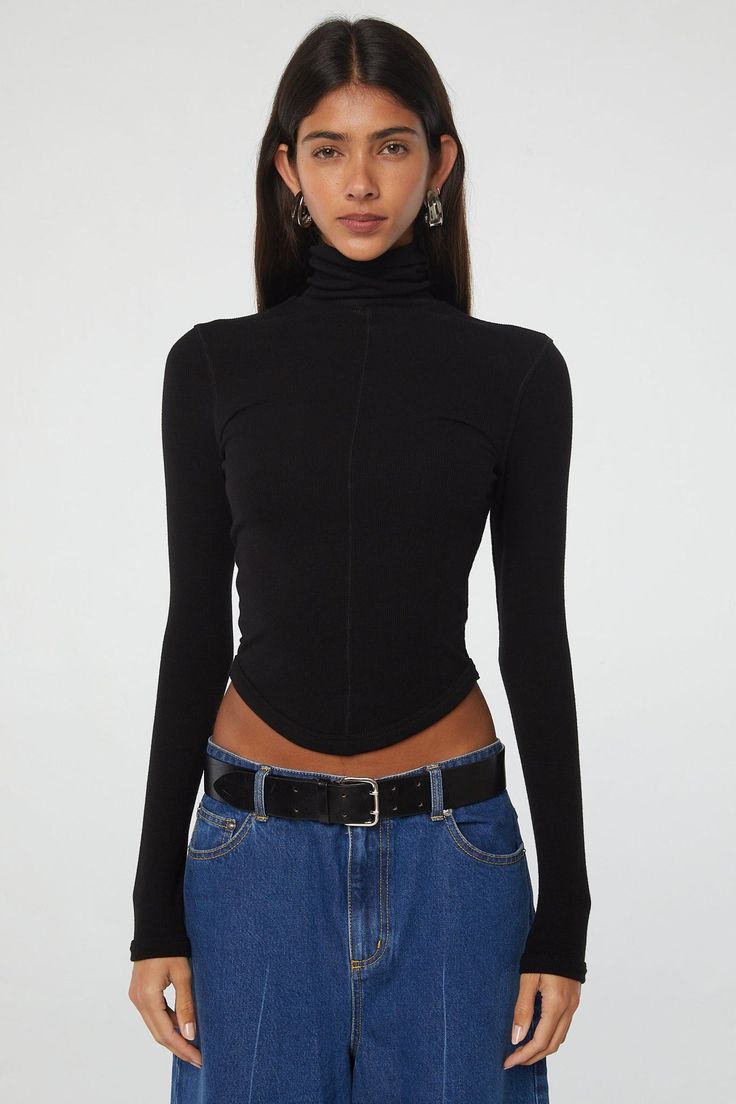 Crafted from our signature mid-weight stretch-rib, the Mads turtleneck top features tonal baby flat lock stitch, a fold-over turtleneck, and a curved hem. High Stretch Funnel Neck Trendy Top, High Stretch Funnel Neck Top, Trendy Style, Trendy High Stretch Tops With Funnel Neck, Trendy High Stretch Funnel Neck Tops, Sleek Stretch Turtleneck Tops, Casual Mock Neck Top With Thumbholes, Chic High-neck Tops With Thumbholes, Sleek Turtleneck Tops With Thumbholes, Winter Mock Neck Top With Thumbholes For Layering