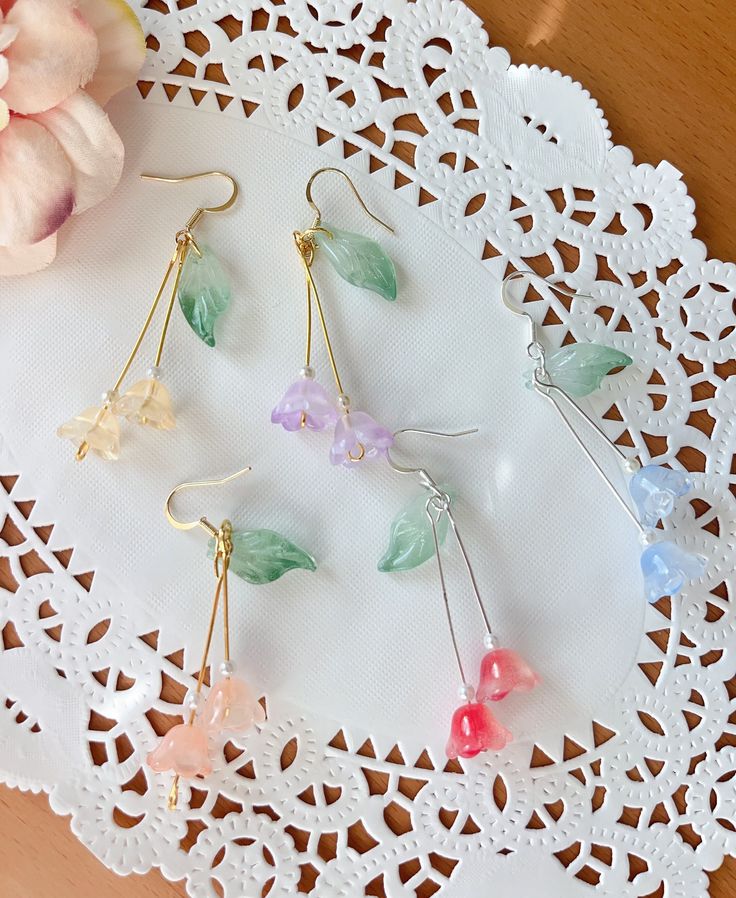 Wisteria earrings These wisteria earrings feature colorful flowers, one green leaf, crystals. Let's keep wisteria blooming! Available in GOLD finish! Also can make in silver. M A T E R I A L S * A N D * S I Z E  The hook is 14k gold filled - Length: 43 mm(without hook) - Width: 12mm Lily of the valley is a symbol of humility and happiness P L E A S E * N O T E No two pieces of jewelries are exactly alike, due to their handmade nature, which makes it more unique! Wrapping Tutorial, Wire Wrapping Tutorial, Lily Of The Valley Flowers, Bracelet Inspo, Wire Wrapped Jewelry Diy, Valley Flowers, Earrings Colorful, Fall Earrings, Shiny Things