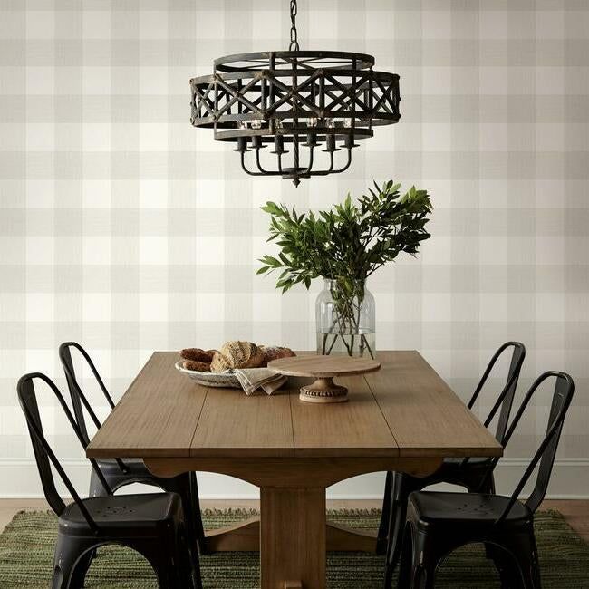 a dining room table with four chairs and a potted plant