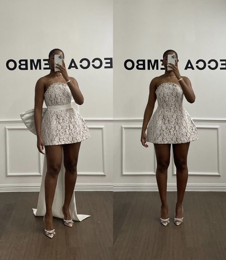 two women standing in front of a white wall and holding cell phones to their faces