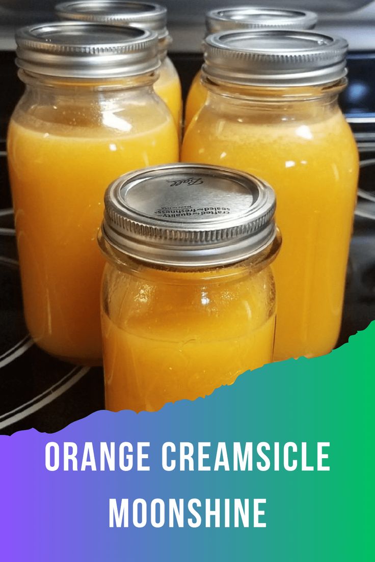 three jars filled with orange creamsice sitting on top of a stove next to each other