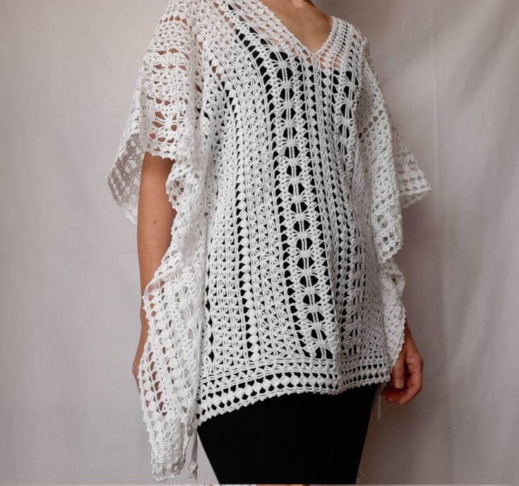 Beach lace tunic, white color, made of mercerized cotton. The pattern gives a nice ethnic look. The width is adjustable, as there are two strings on both sides (Romanian cord made also by hand) of the same thread. It can be worn as a short caftan, a beach dress, or swimsuit cover up. The cotton and the lace pattern give a pleasant cooling effect, helping to enjoy the summer days.  Made in smoke free, pet friendly environment.  Length: 27'' or 68 cm Width: 31'' or 78 cm Neck opening depth: 7.5'' White Crochet Bohemian Cover-up, White V-neck Crochet Dress For Beach, White Crochet Lace Top For Beach Cover-up, White Poncho For Spring Beach Cover-up, White Crochet Lace Beachwear Cover-up, White Crochet Lace Beach Cover-up, White Crochet Beach Dress For Beach Season, White Crochet Cover-up For Festival, Bohemian White Crochet Dress For Beach Season