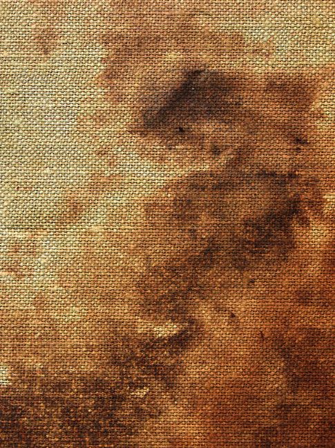 an old textured paper background with brown and black stains on the bottom half of it