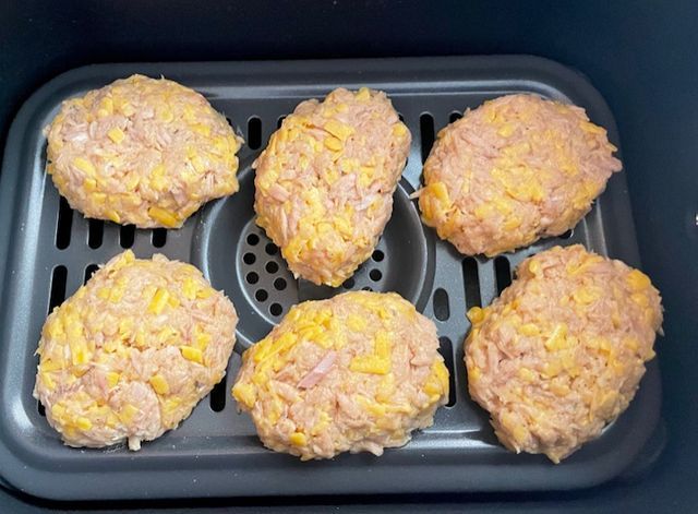 six hamburger patties sitting on top of an air fryer